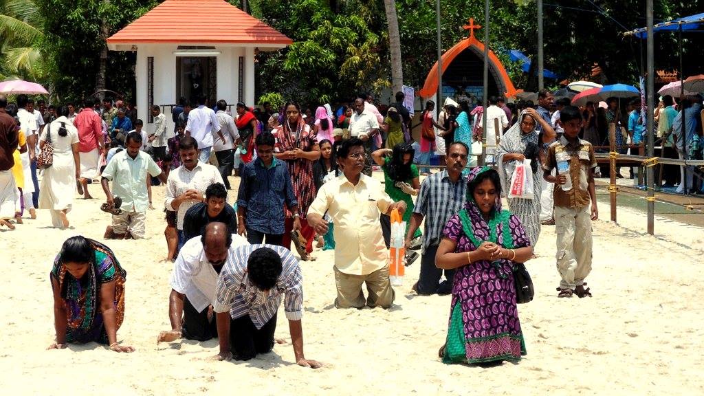 Pilgrims approaching Thankey Church on their knees on Good Friday